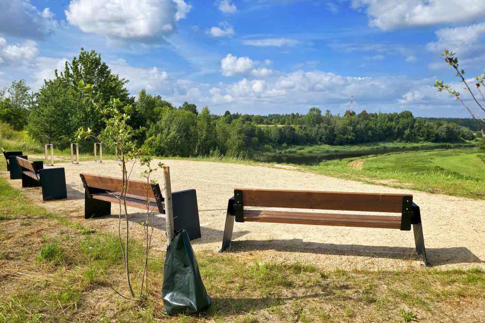 Landscaped resting area with benches at Melna kolka in Kuldiga