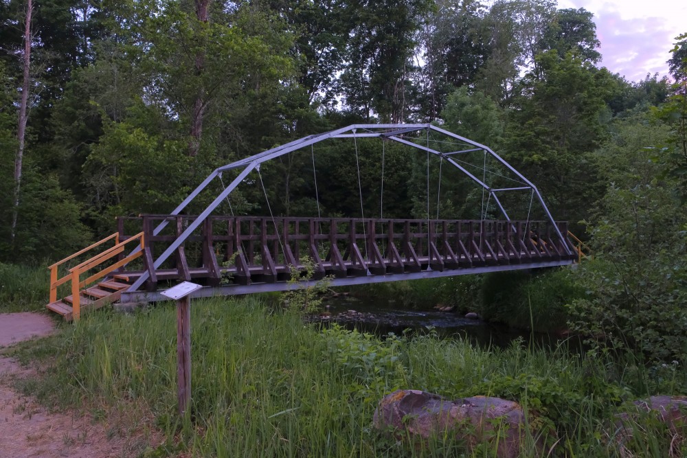 Pedestrian Bridge over Mergupe River in Mālpils