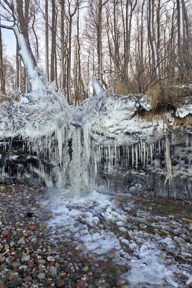 Winter ice formations at Staldzene Waterfall by the coastal cliff