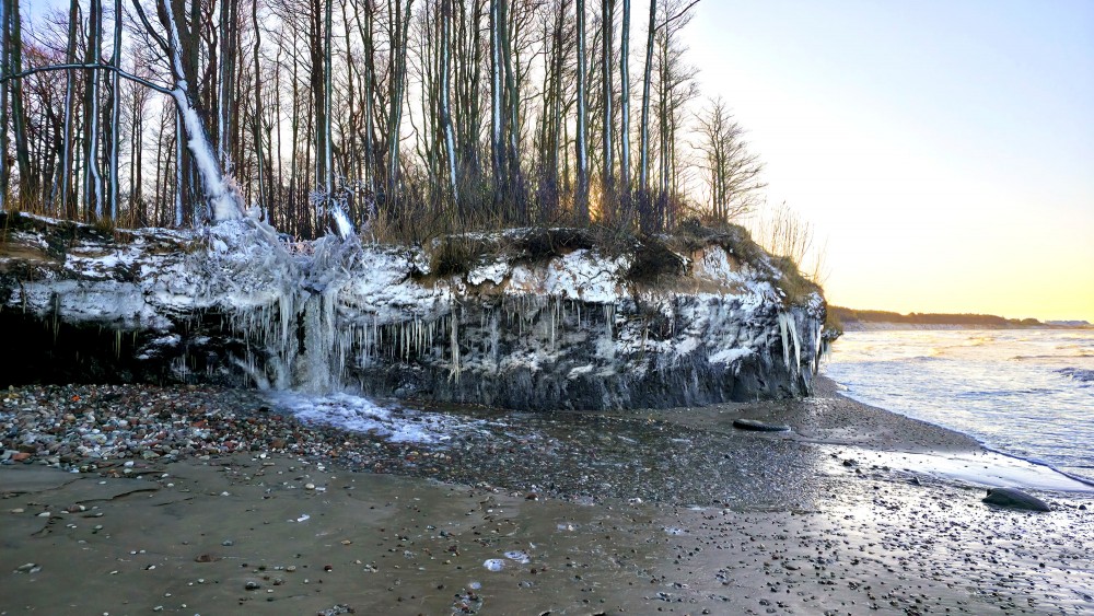 Ziemas piekrastes ainava ar Staldzenes ūdenskritumu un apledojušu stāvkrastu