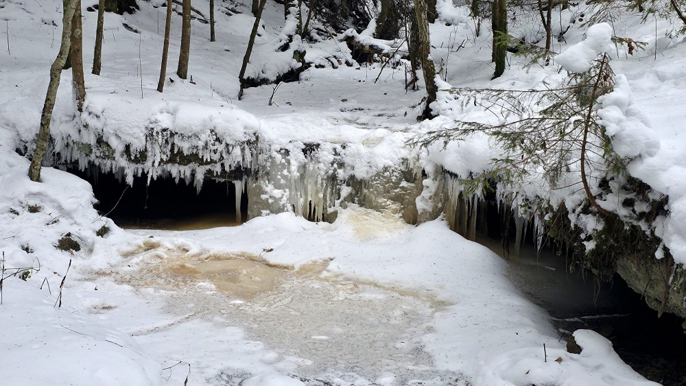 Winter view of icy edges at the Oļupīte waterfall