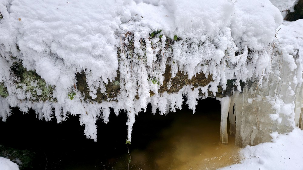 Icicle formations at the Oļupīte waterfall in winter