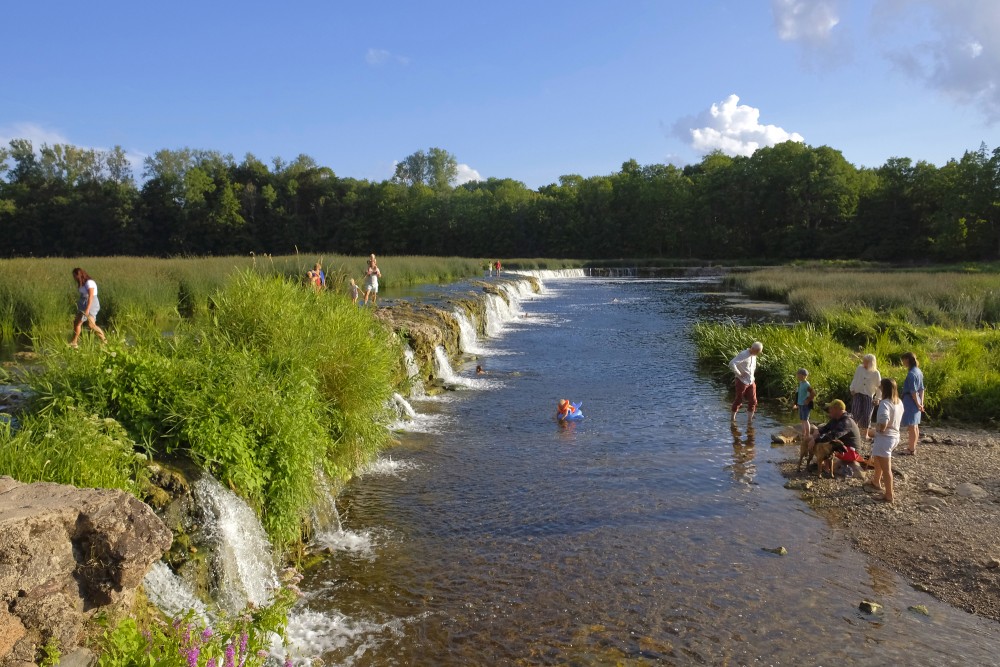 People walk across the Venta Rapid, Latvia