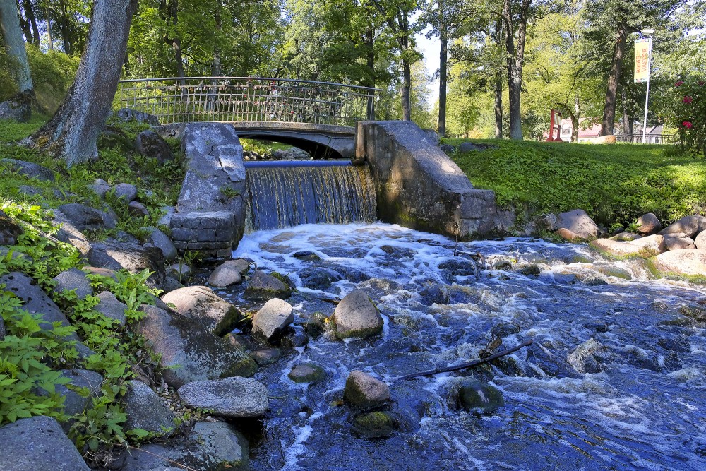 Small Bridge over the Mārupīte Stream in Arkādija Park with a Weir