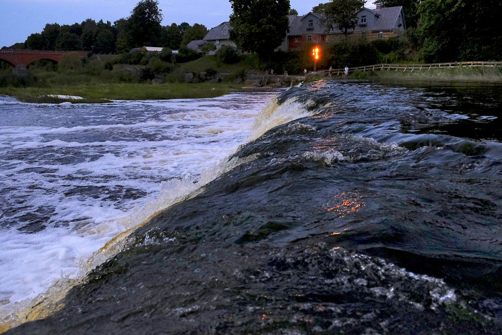 Venta Rapid in the Late Evening with Illuminated Riverbank and Flowing Water