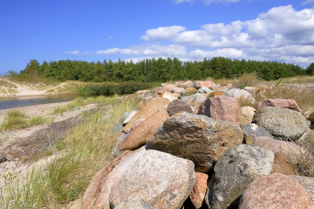 Stone jetty at Pape Canal in a natural coastal landscape
