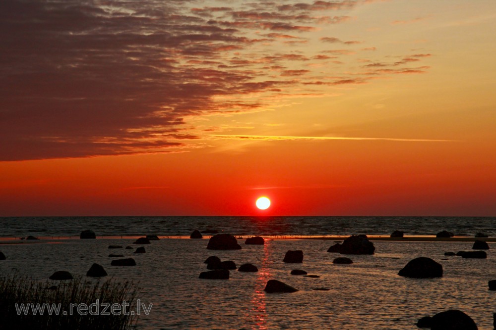 Sunrise at stony shore in Mersrags, Latvia