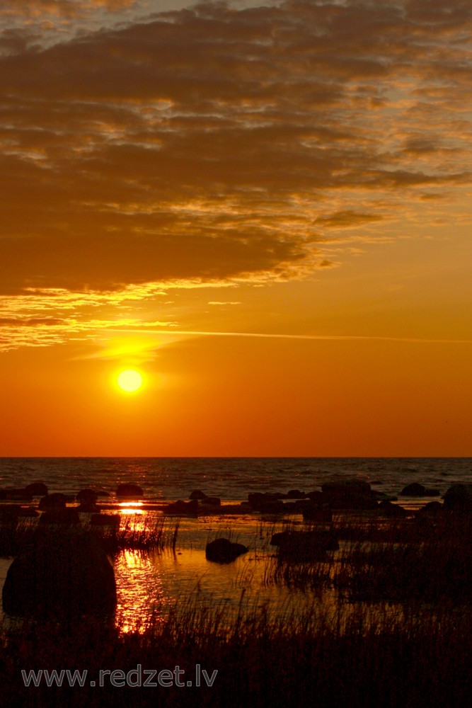 Sunrise at stony shore in Mersrags, Latvia