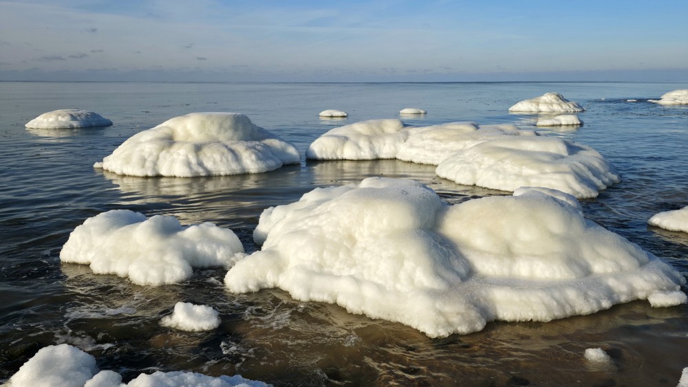 Icy rocks and rounded ice formations on Užava beach