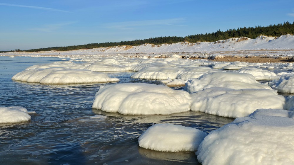 Winter landscape with ice mounds and dunes in Užava