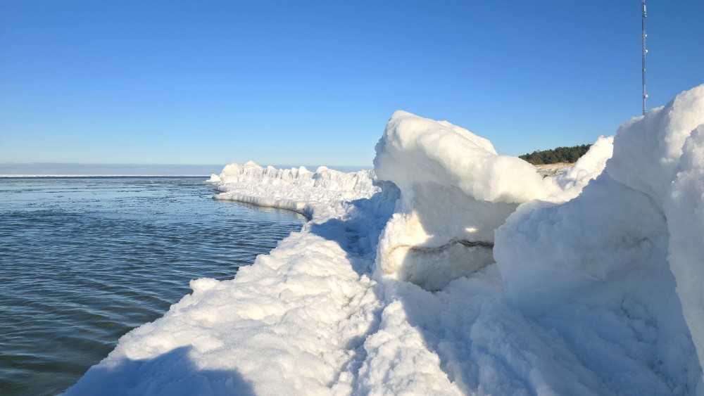 Ice ridges and snow banks on the Baltic Sea coast on a sunny day