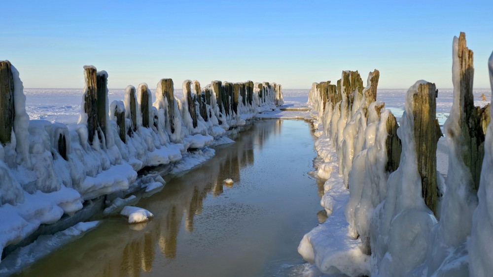 Winter landscape with icy piles on the Bigauņciems shore