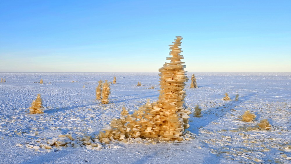 Tall ice plate tower in the winter coastal landscape of Bigauņciems