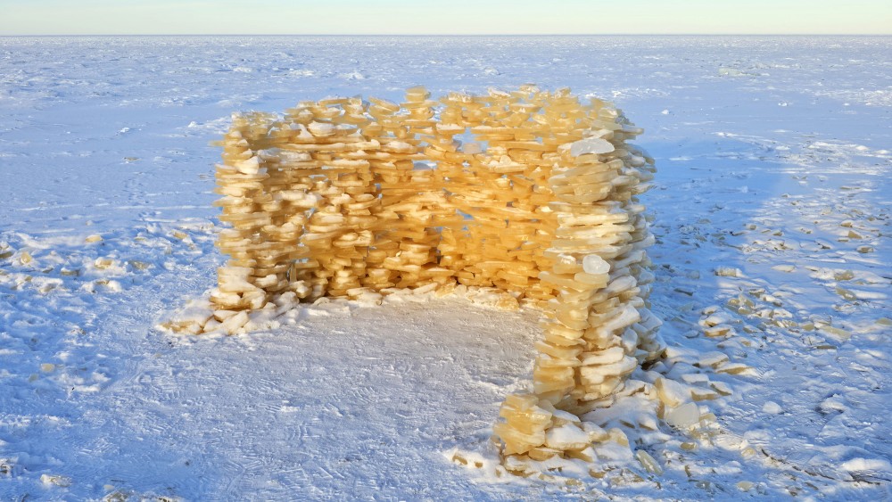 Semi-circular shelter built from ice plates at Bigauņciems Beach
