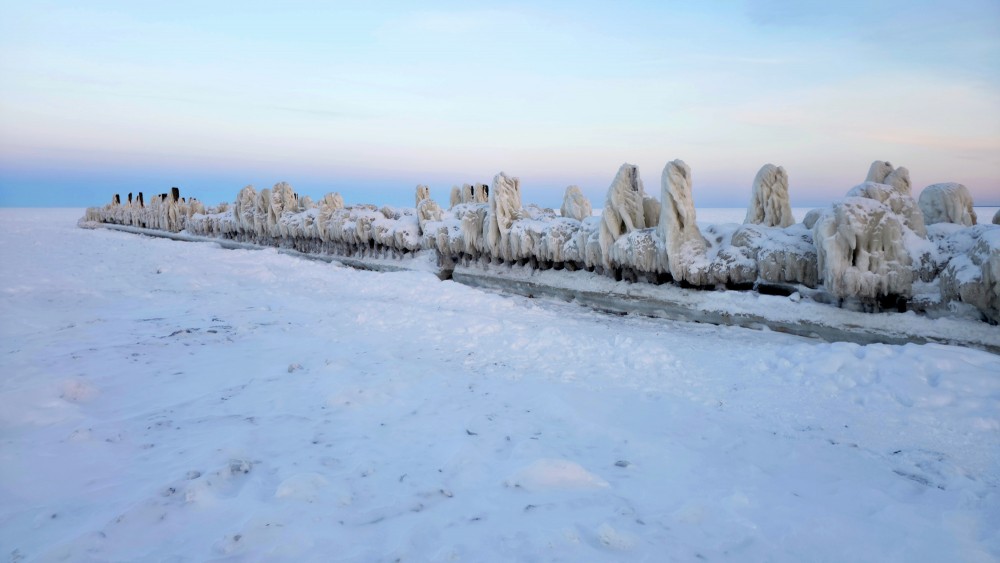 Panoramic view of the icy Engure breakwater in winter