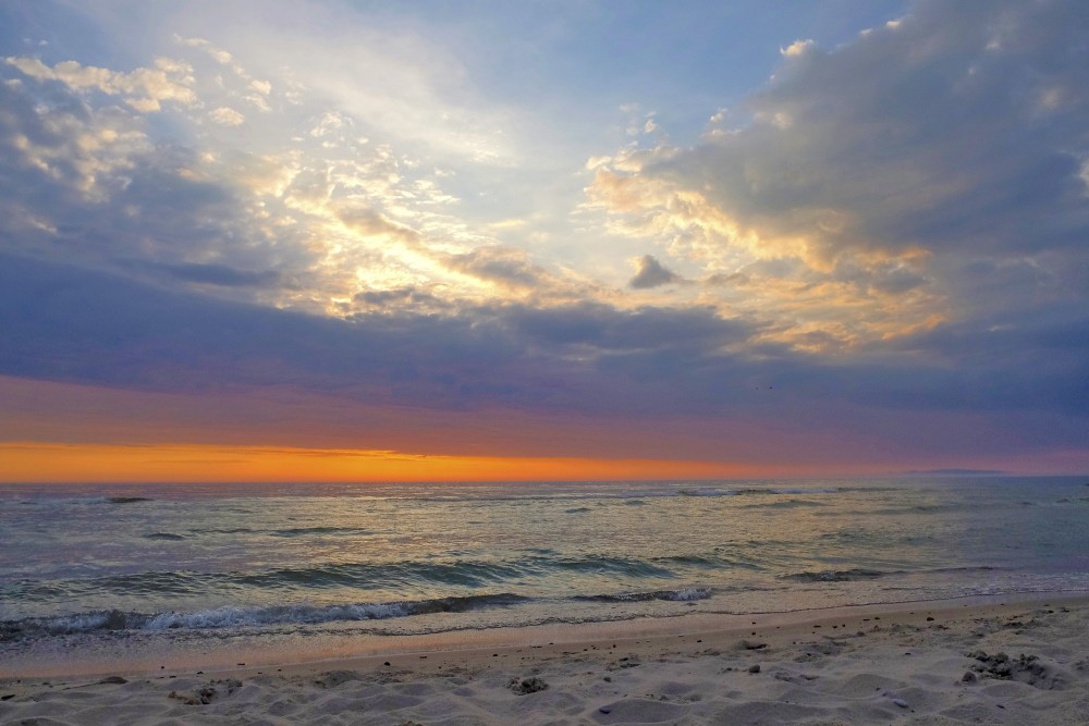 Saulriets Baltijas jūrā, mākoņainas debesi