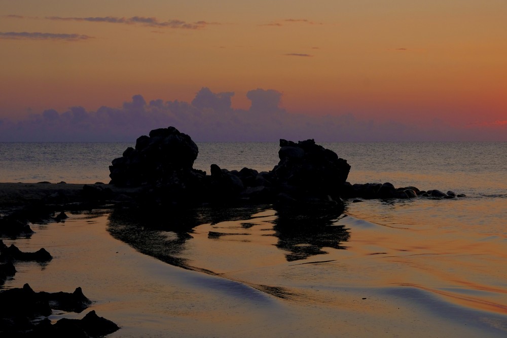 The cloud copies the outlines of the ruins of the old lighthouse at Cape Kolka