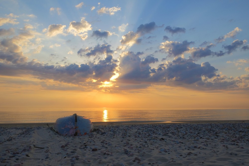 Beautiful Sunset Sky, a Boat on the Seashore