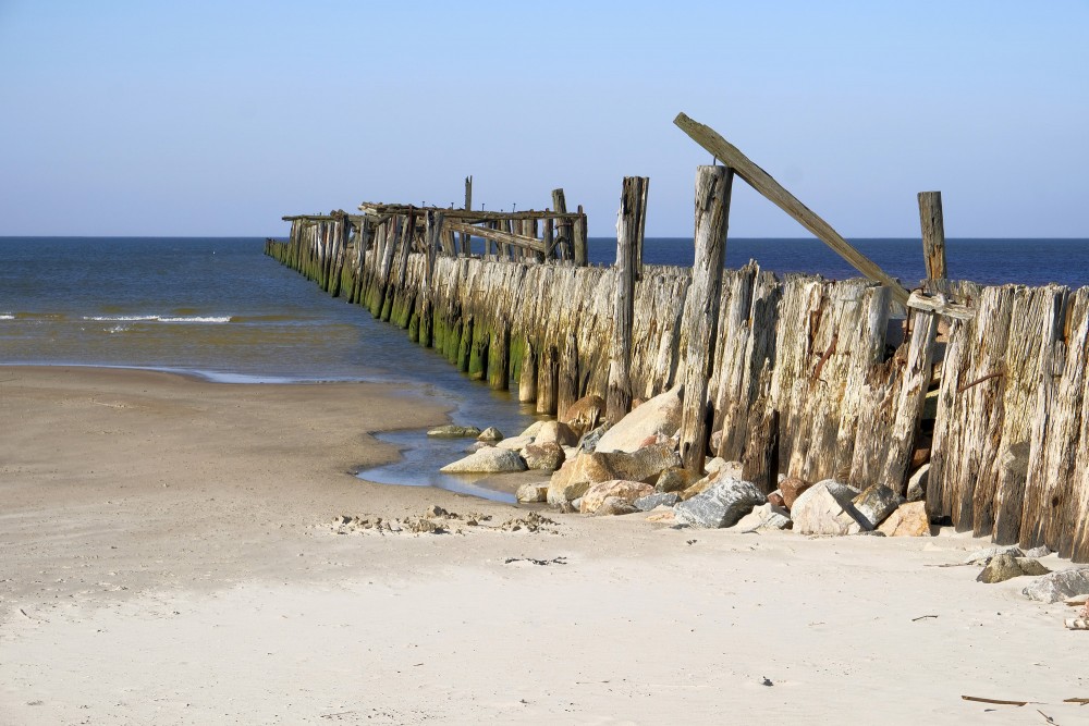 The Old Wooden Pier of Šventoji with a rocky shoreline