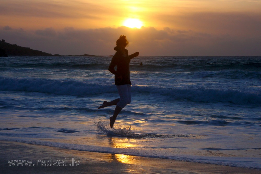 Girl Jumping at Sunset