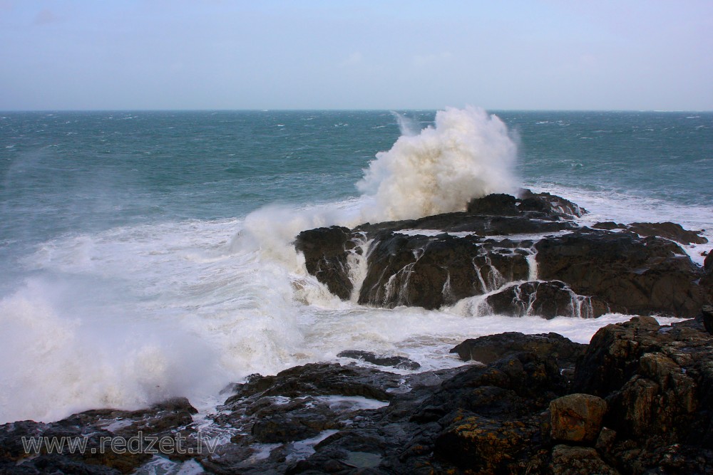 Waves Hit the Rocks