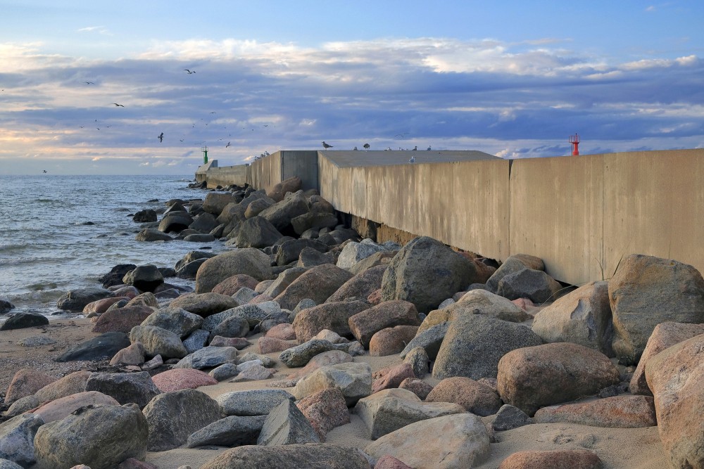 Concrete wall and boulder pile of the Pavilosta south pier