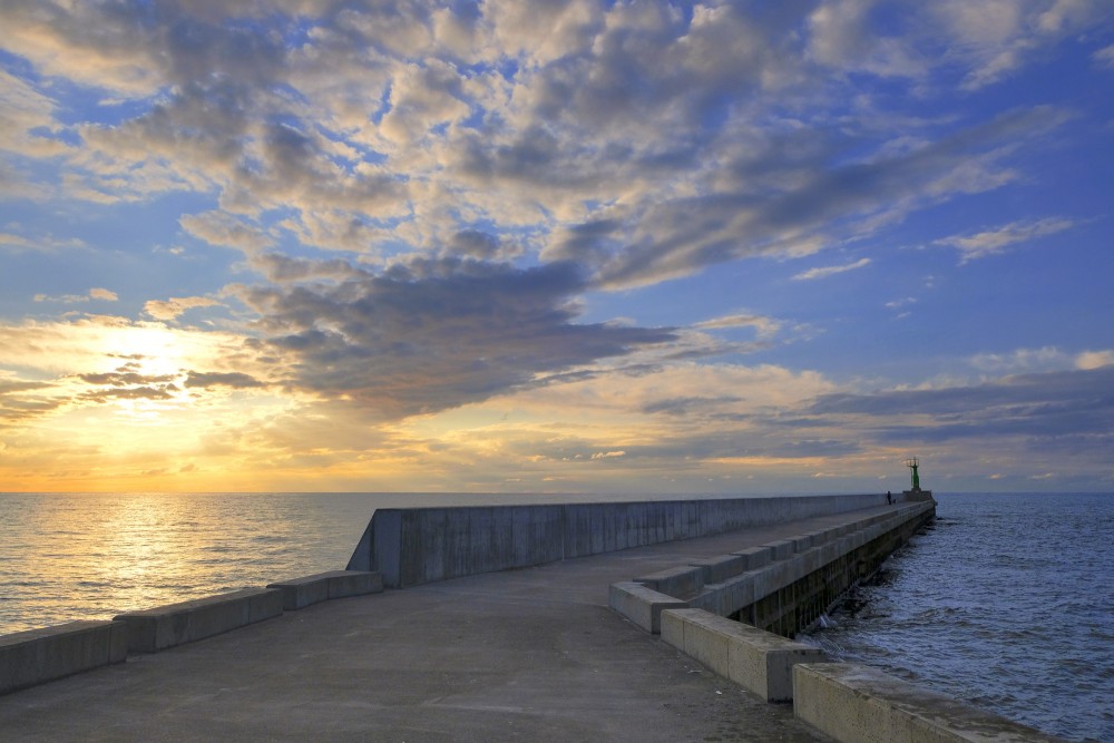Sunset view from the Pavilosta south pier toward the sea Sunset view from the Pavilosta south pier toward the sea
