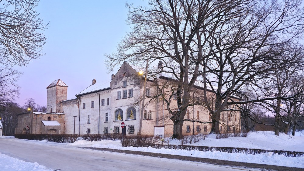 Dundaga Castle in winter with snow, old trees and evening light