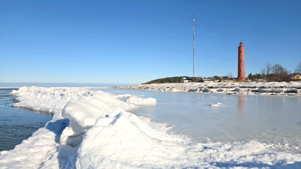 Ice ridges by the Baltic Sea and Akmensrags Lighthouse