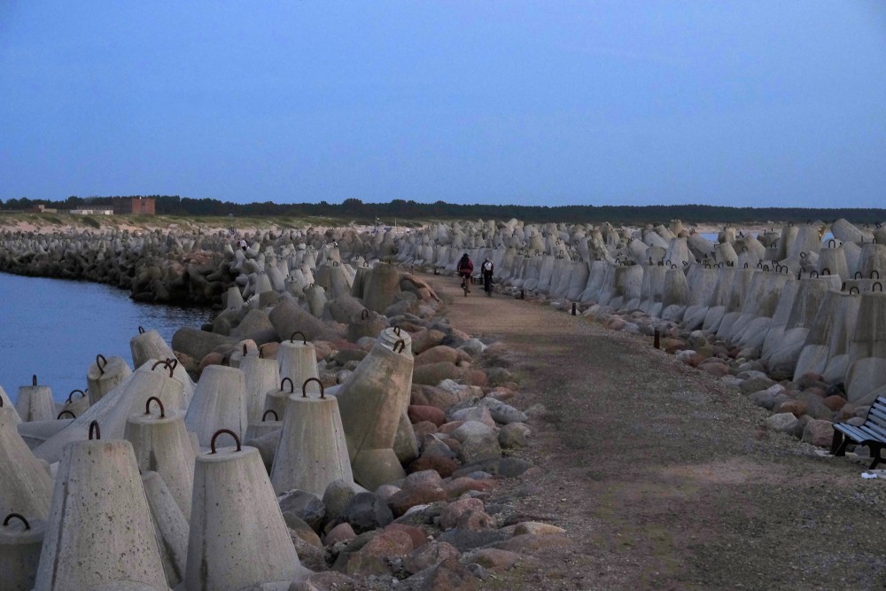 Ventspils Southern Pier at dusk with cyclists