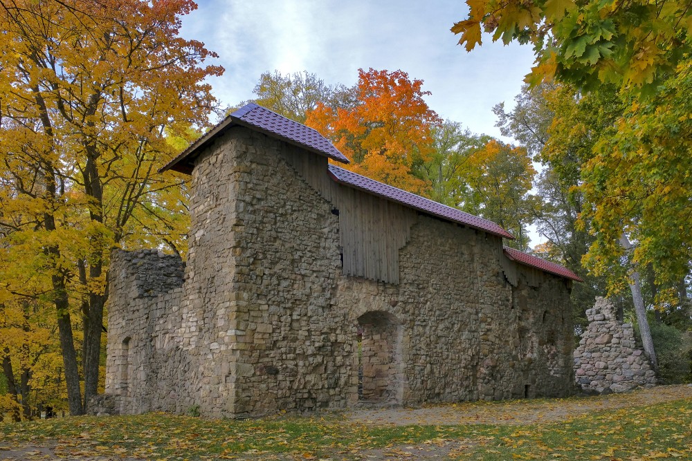 Lielvārdes bruņinieku pils mūra ēka rudenī koku ieskautā ainavā