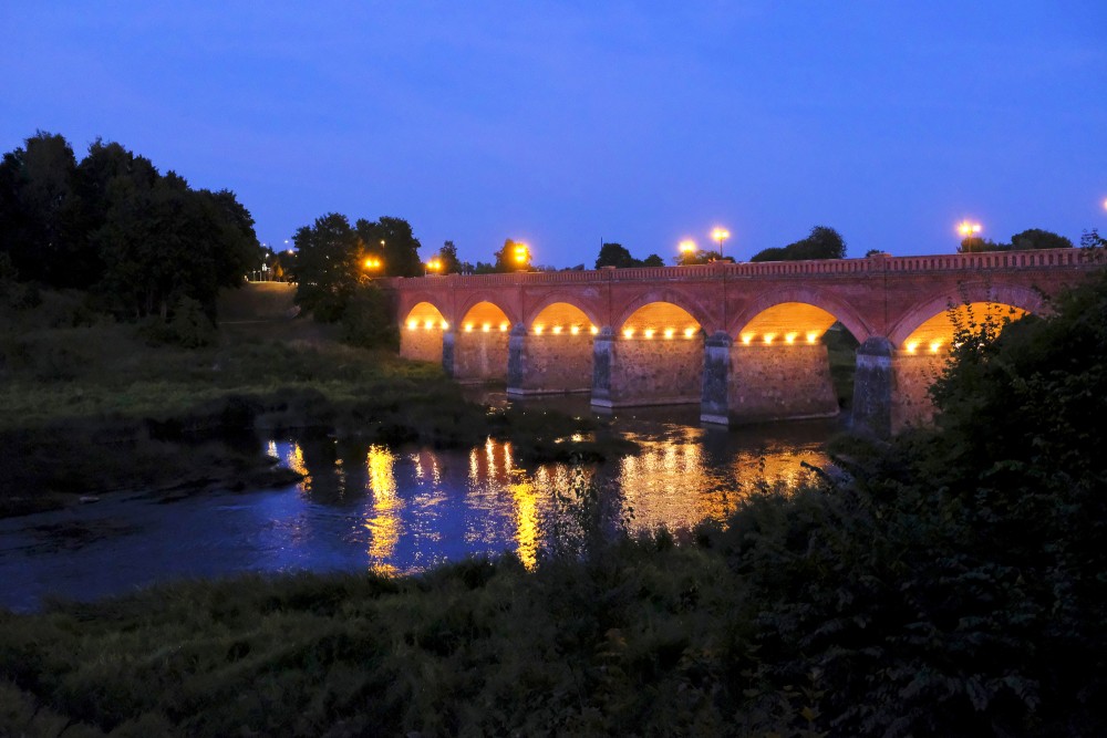 The Ancient Brick Bridge of Kuldiga at Night