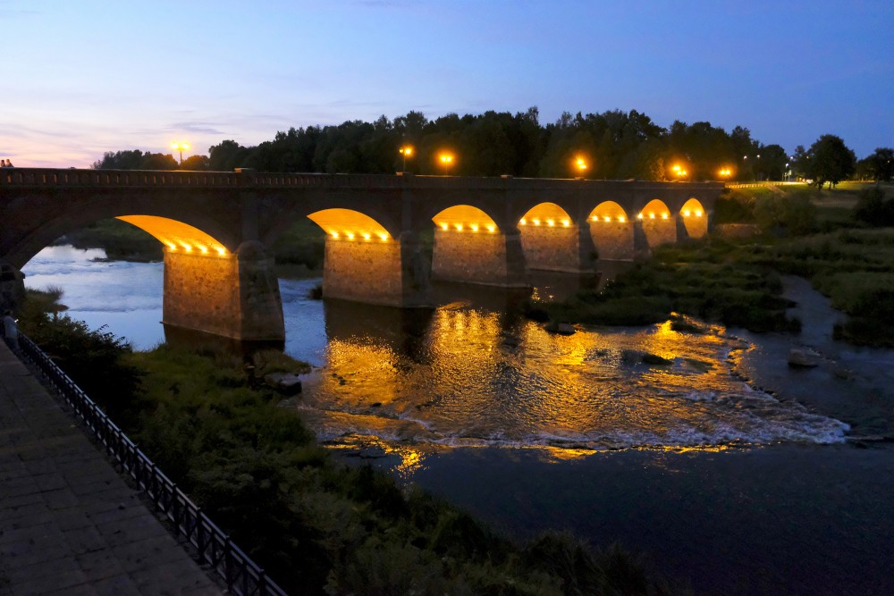 The Ancient Brick Bridge of Kuldiga at Night