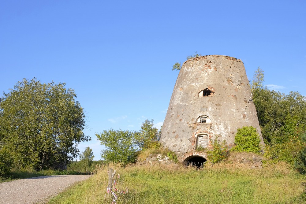 The ancient ruins of Minde windmill next to a country road