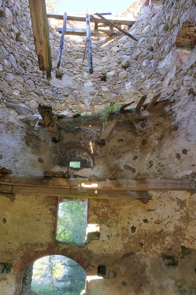 View of the collapsed wooden ceilings and interior of Minde windmill