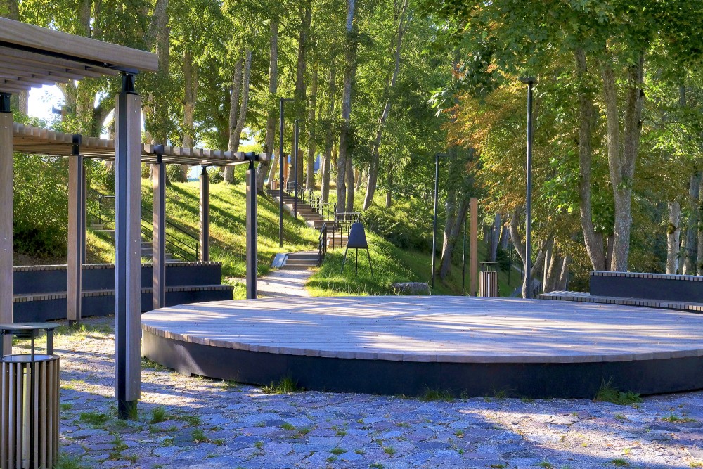 Outdoor wooden stage and pedestrian pathways at Keninkalns park in Talsi