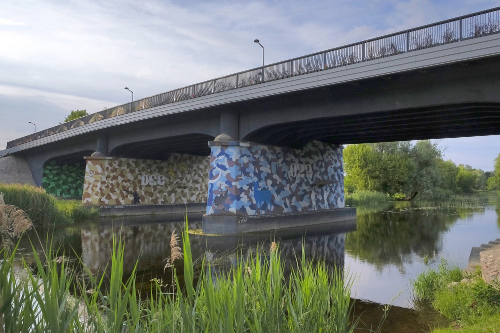 Vilkaviškis bridge with painted pillars over the Šešupė river in Marijampolė