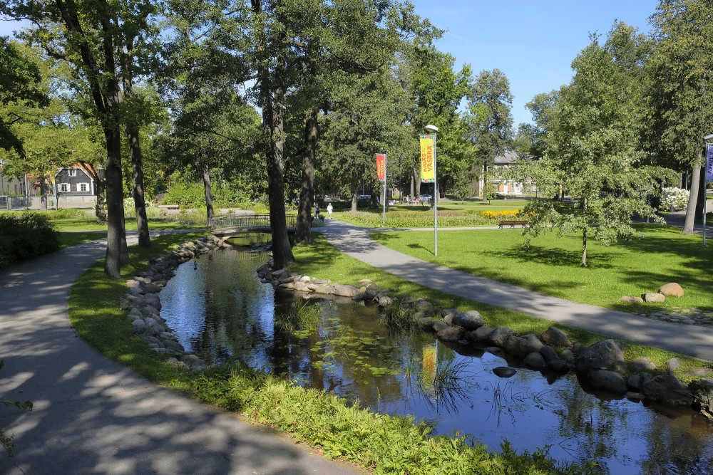Arkadija Park with Marupe Stream, walking paths and tree-lined landscape on a sunny day
