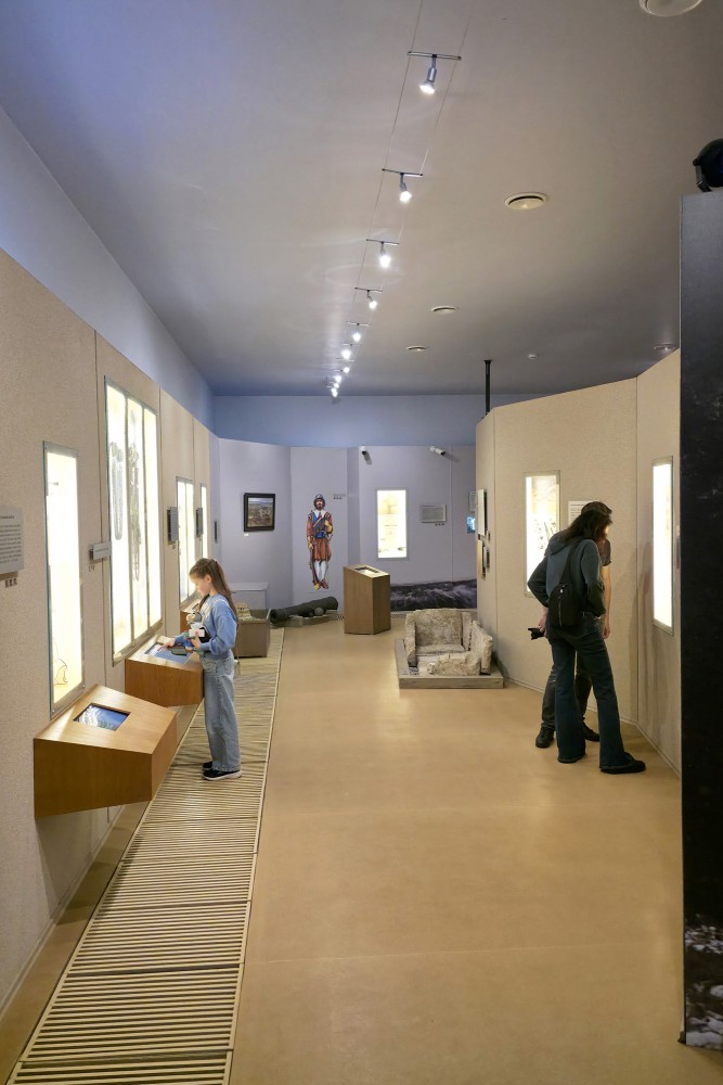 Historical exhibition hall with visitors at the Daugava Museum