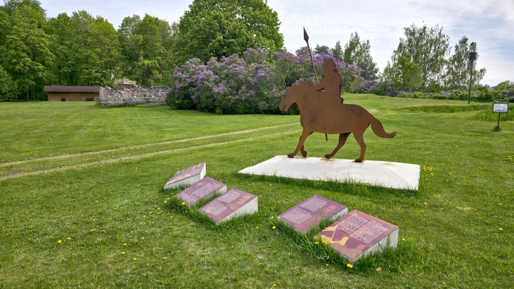 Metal rider silhouette and information stands in the open-air territory of the Daugava Museum