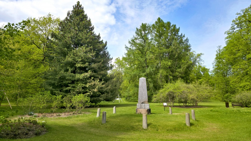 Lewis of Menar family memorial stone in a green park in summer