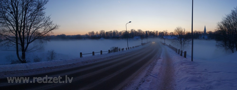 Kuldīgas panorāma miglainā ziemas vakarā