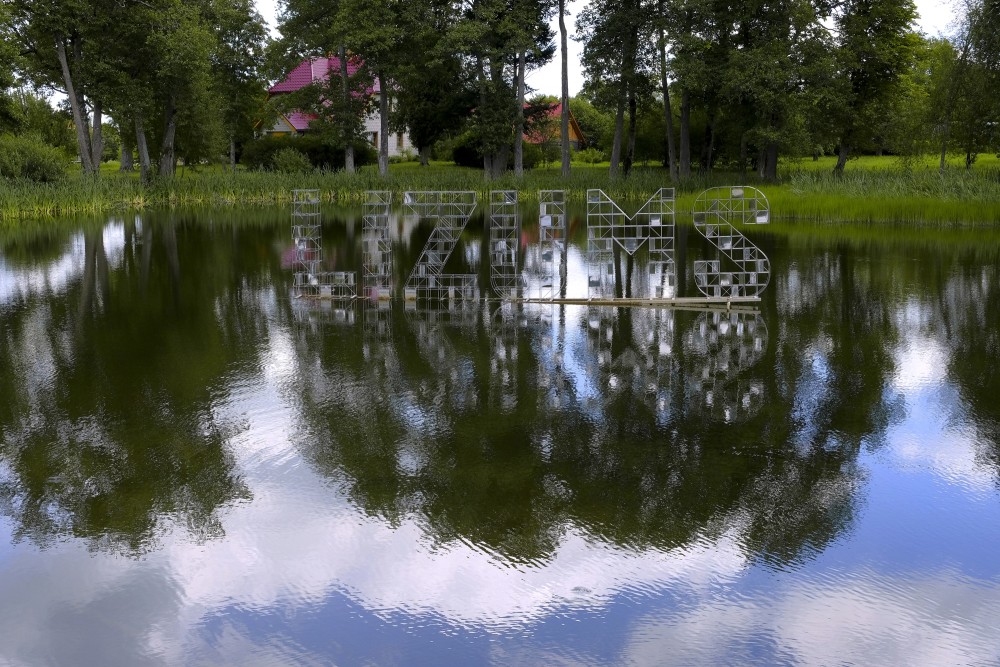 Sign "Lizums" in Lizums Pond