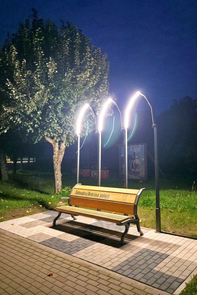 Tālivaldis Deksnis musical bench in Aizpute with illuminated arches at night