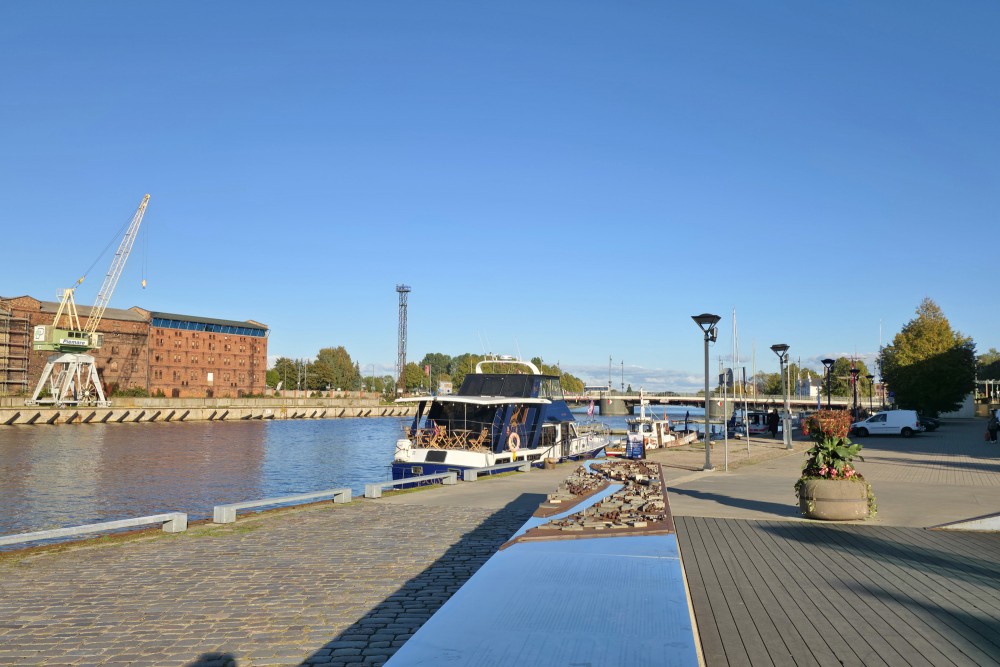 Liepaja trade canal promenade with boat and port crane
