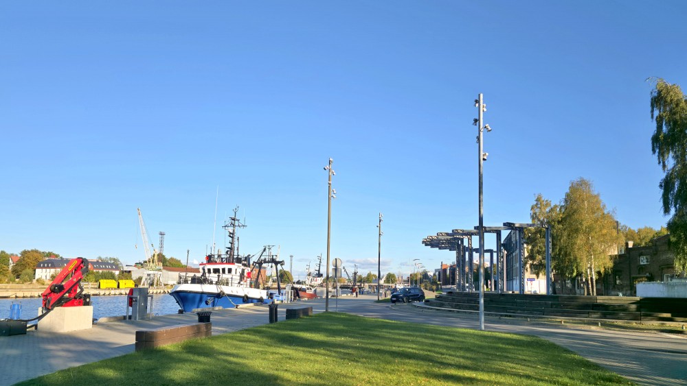 Liepaja canal promenade with ships, amphitheater and urban elements