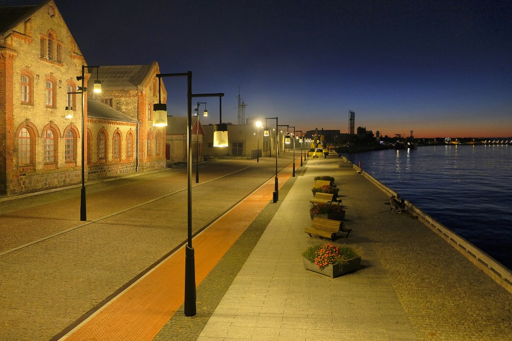 Ostas Street promenade in Ventspils illuminated in the evening by the Venta River