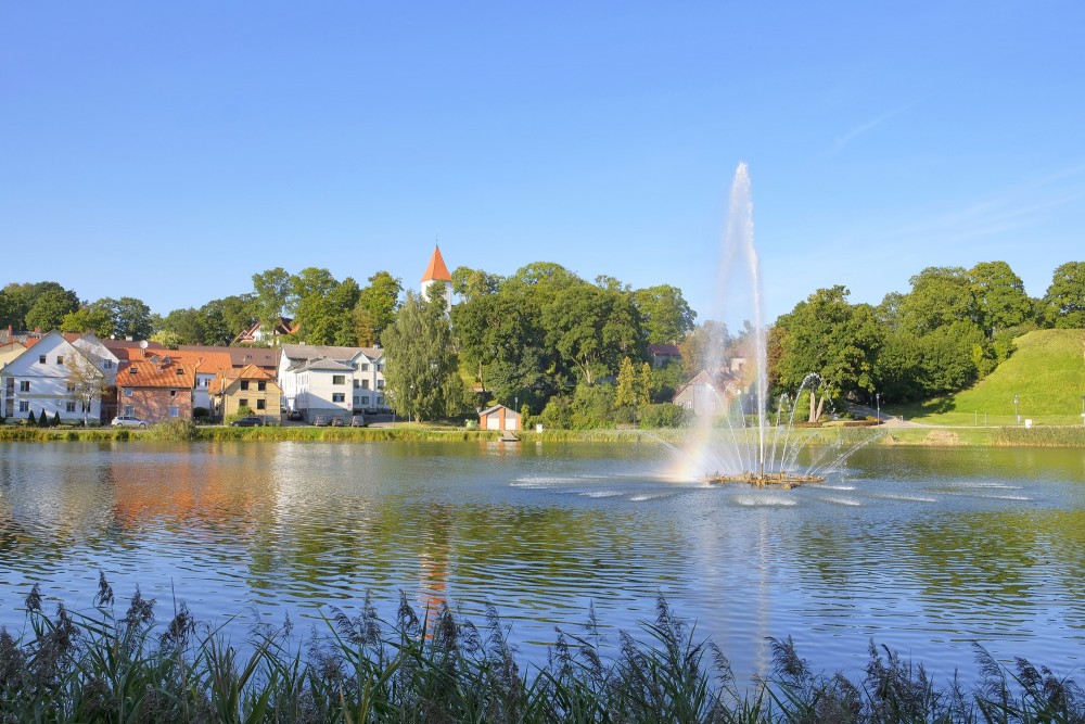 Talsi lake with fountain, rainbow and town landscape