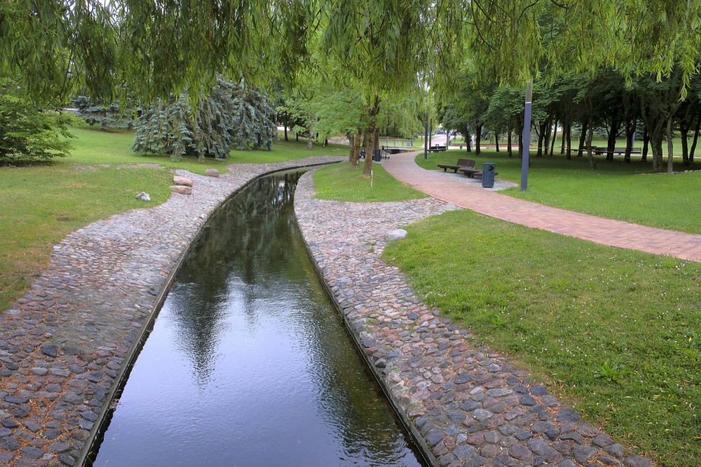 Stone paved canal and walking path in Marijampole Poetry Park