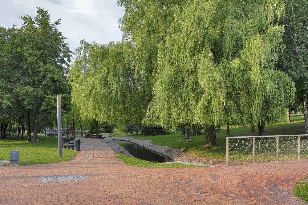 Willow canopy and paved plaza in Marijampole Poetry Park